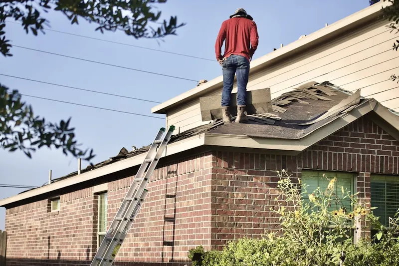 Professional roofer working on a residential roof in Tome Estates